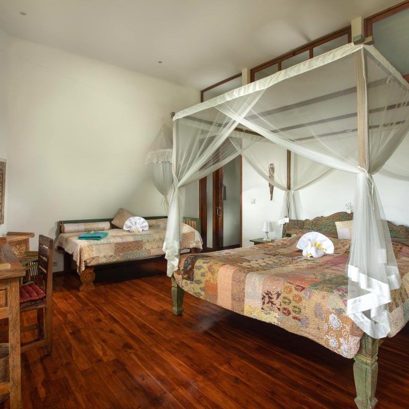 Orchid Room with one big double bed and one small bed